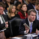 Supreme Court nominee Judge Brett Kavanaugh holds a copy of the Constitution as he testifies before the Senate Judiciary Committee on the third day of his Supreme Court confirmation hearing on Capitol Hill September 6, 2018 in Washington, DC.